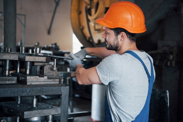 worker installing machine in industry - the machinery installation process from plan to reality