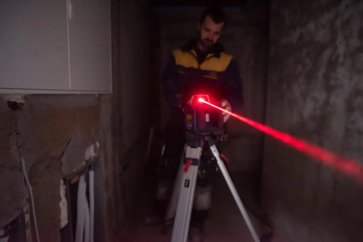 professional-worker-using-laser-level-building-construction-laser-equipment-construction-site