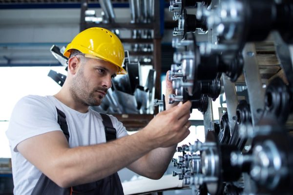 worker repairing equipment - industrial millwrighting trends, challenges, and opportunities in the industry