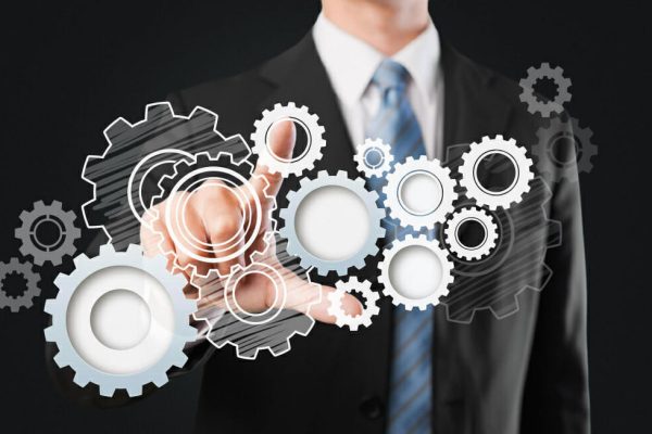 busniess working on industry reorganization - Revitalizing Your Business: The Benefits of Six Sigma Reorganization