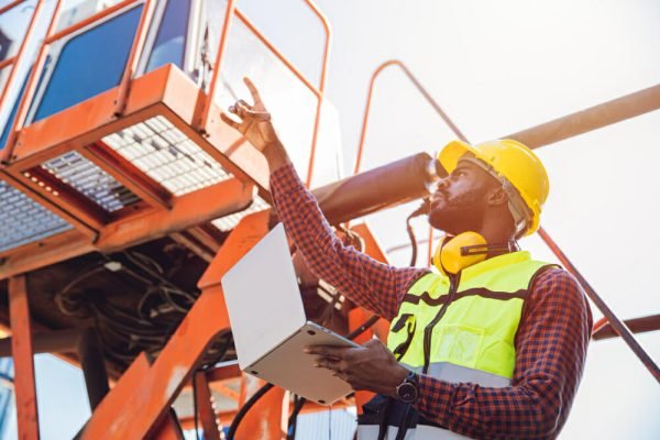 worker pre-checking crane safety regulations - crane safety regulations a guide to ensuring compliance