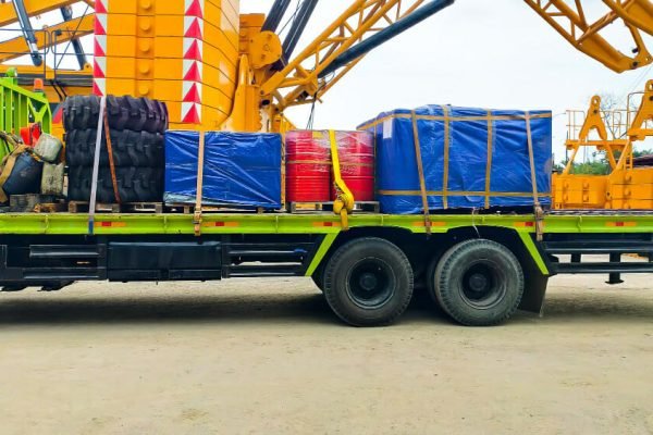 Truck loaded with heavy industrial machinery - securing heavy machinery for transport a comprehensive guide by alltracon
